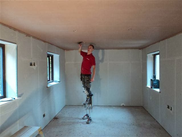 Chris plastering on stilts